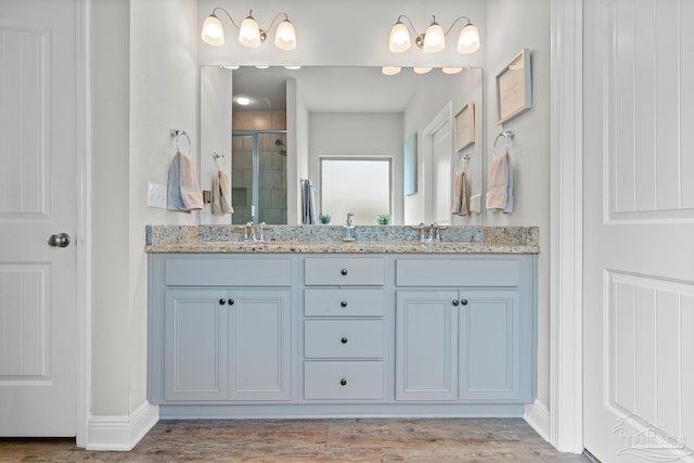 6347 Ladera Trl, Pace, FL 32571 - full bath featuring a stall shower, wood finished floors, double vanity, and baseboards