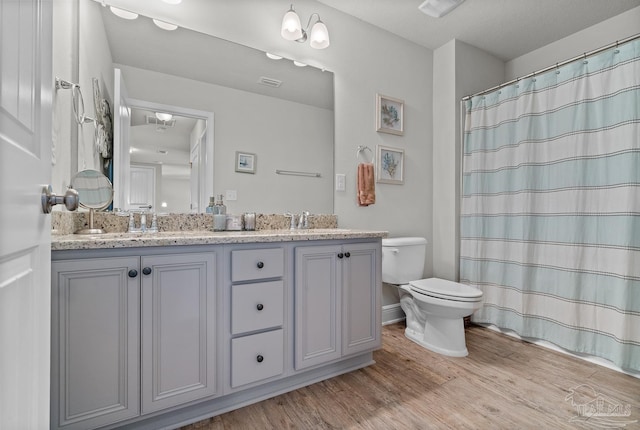6347 Ladera Trl, Pace, FL 32571 - bathroom with toilet, wood finished floors, double vanity, and a shower with shower curtain