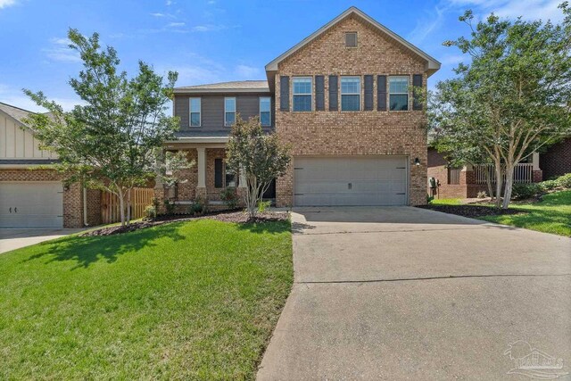 6347 Ladera Trl, Pace, FL 32571 - view of front of home featuring brick siding, driveway, a front lawn, and a garage