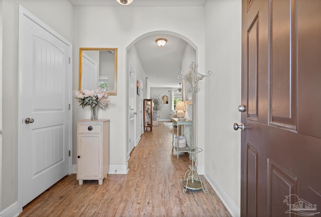 6347 Ladera Trl, Pace, FL 32571 - foyer entrance with light wood-style flooring, arched walkways, and baseboards