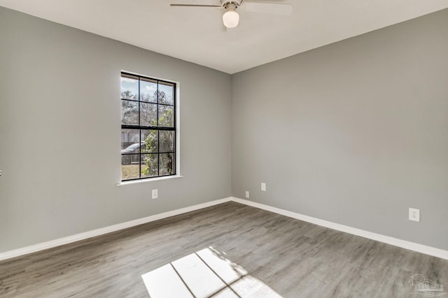 spare room with hardwood / wood-style floors and ceiling fan