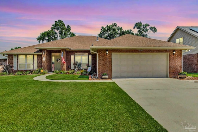 ranch-style house with a lawn and a garage