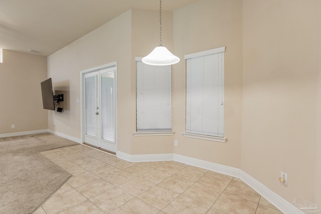 unfurnished dining area with light tile patterned flooring