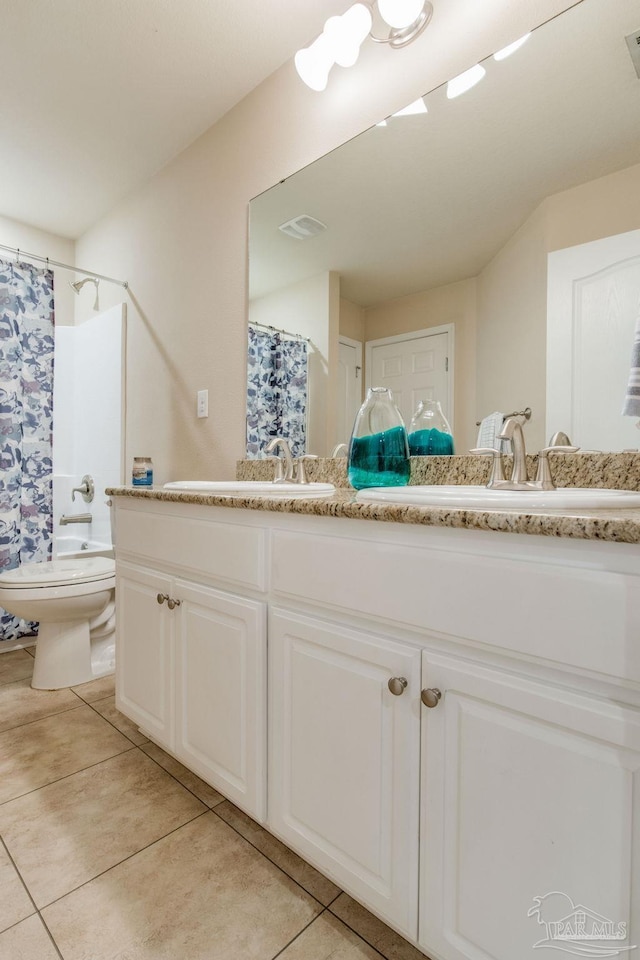 bathroom with tile patterned flooring, a shower with curtain, vanity, and toilet