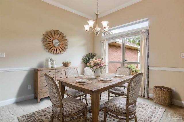 dining room featuring ornamental molding and a notable chandelier