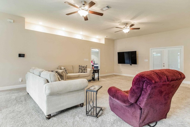 carpeted living room featuring ceiling fan and french doors