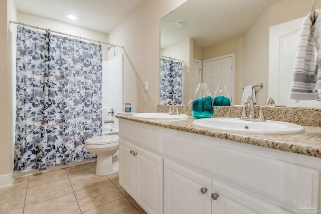 bathroom with vanity, toilet, and tile patterned floors