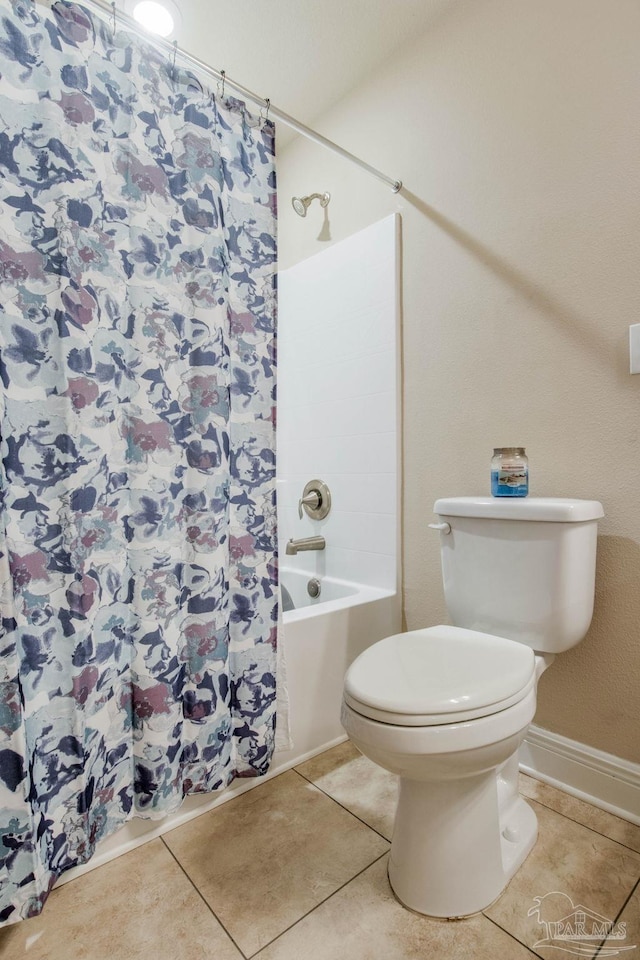 bathroom with shower / bath combo, tile patterned flooring, and toilet