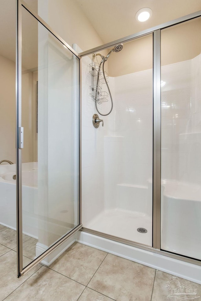 bathroom featuring tile patterned floors and a shower with shower door