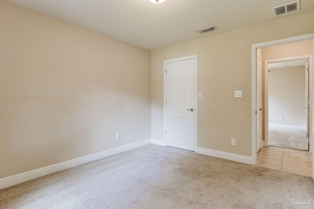 unfurnished bedroom featuring light carpet