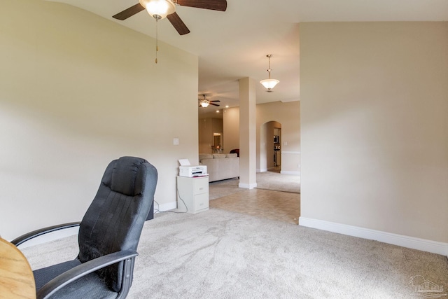 carpeted office space featuring ceiling fan