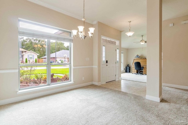 carpeted entryway with ceiling fan with notable chandelier and ornamental molding