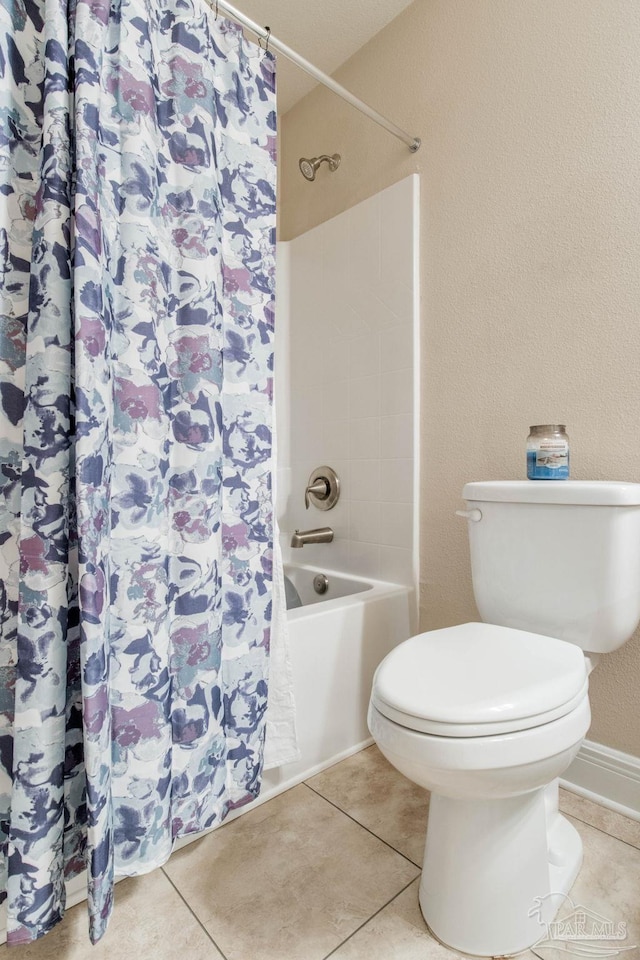 bathroom featuring shower / bathtub combination with curtain, toilet, and tile patterned floors