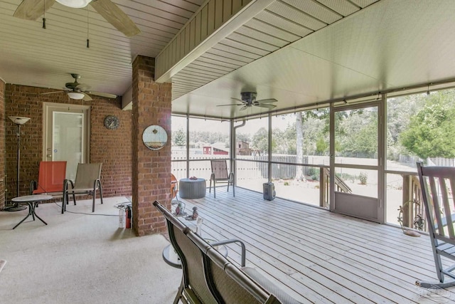 sunroom / solarium featuring ceiling fan