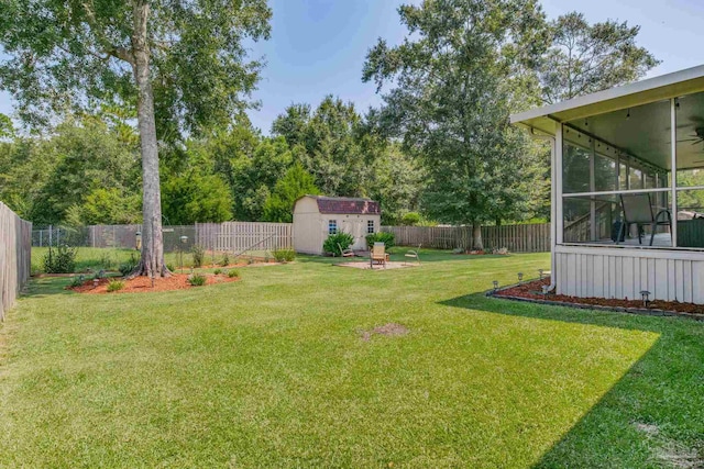 view of yard with a sunroom and a shed