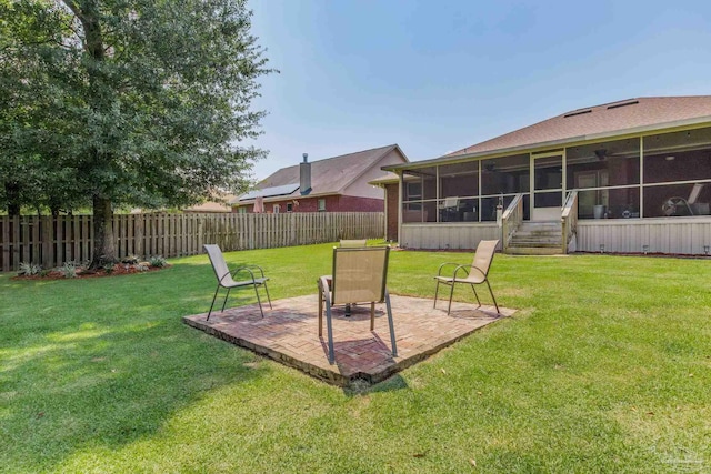 view of yard with a sunroom and a patio area