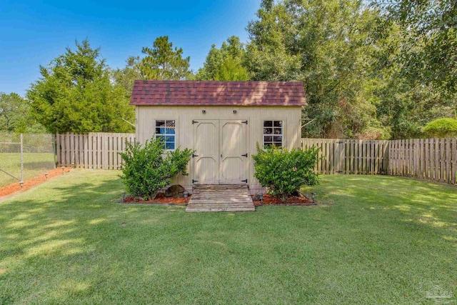 view of outbuilding with a yard