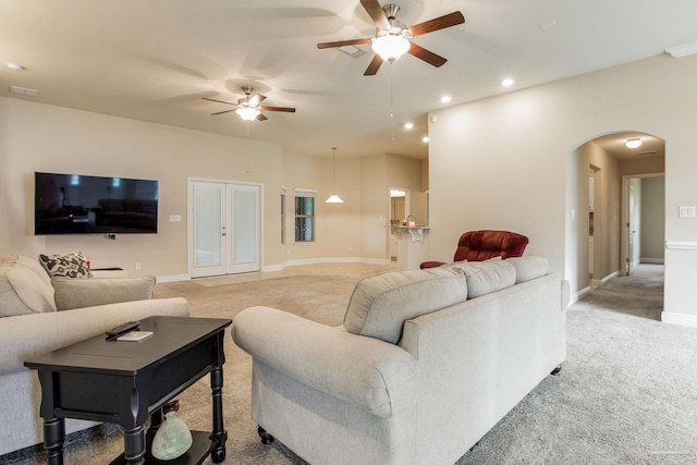 carpeted living room with ceiling fan