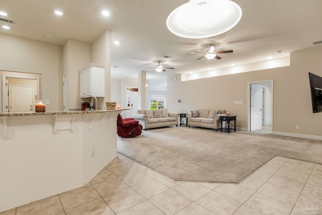 living room with light carpet and ceiling fan