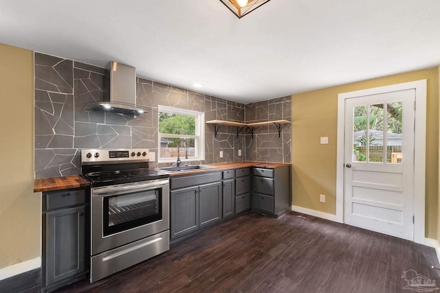 kitchen with stainless steel electric stove, wall chimney exhaust hood, gray cabinets, dark hardwood / wood-style floors, and sink