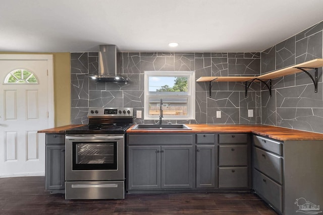 kitchen featuring plenty of natural light, sink, wall chimney range hood, dark hardwood / wood-style flooring, and stainless steel electric range