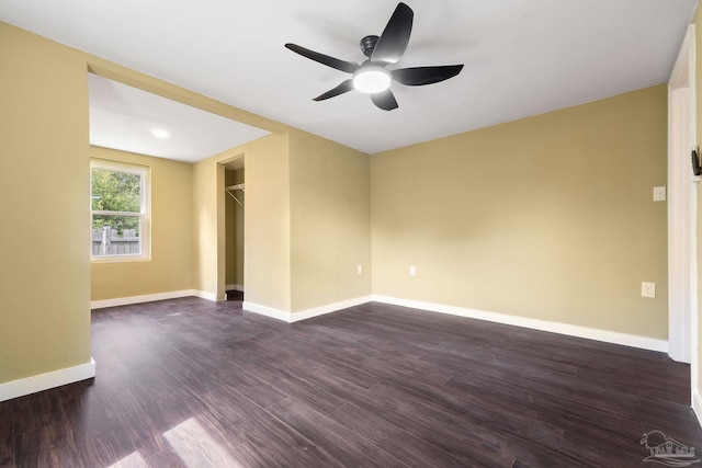 spare room featuring ceiling fan and dark wood-type flooring