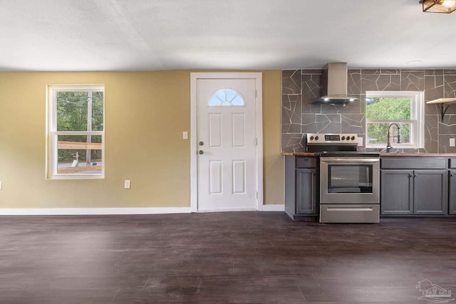 kitchen with a wealth of natural light, electric stove, dark hardwood / wood-style floors, and wall chimney range hood