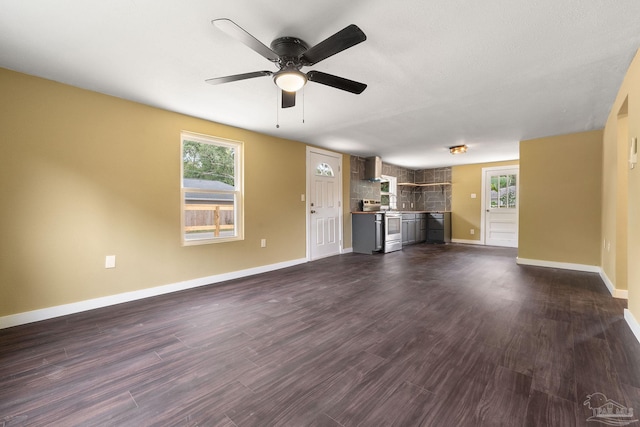 unfurnished living room with ceiling fan and dark hardwood / wood-style floors