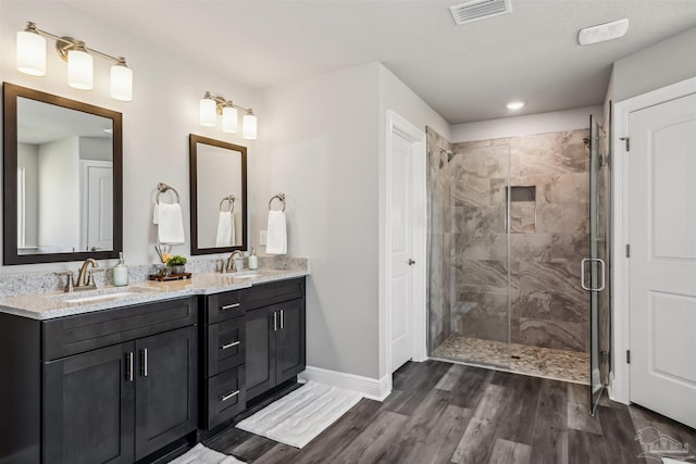 bathroom featuring vanity, an enclosed shower, and hardwood / wood-style flooring