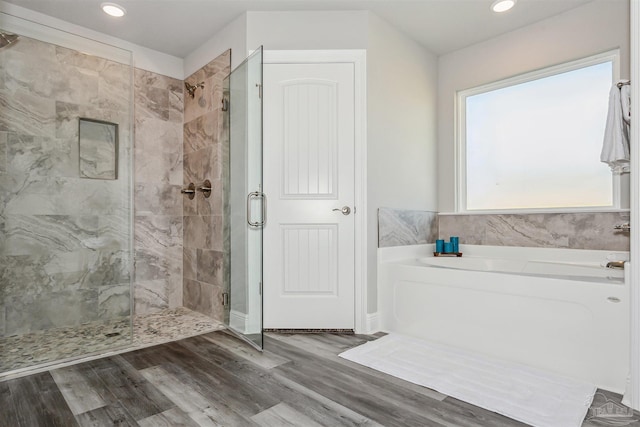 bathroom featuring separate shower and tub and wood-type flooring