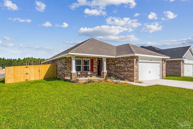 view of front of home with a garage, covered porch, and a front yard