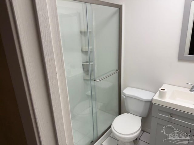 bathroom with vanity, toilet, and an enclosed shower