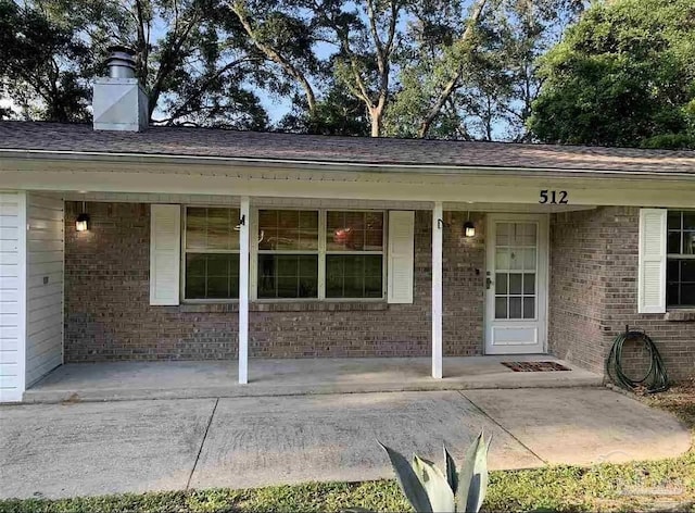 doorway to property featuring covered porch