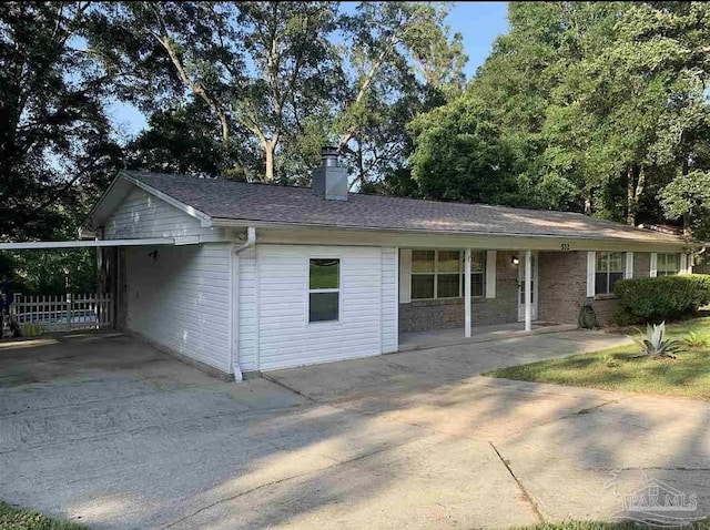 single story home featuring a carport