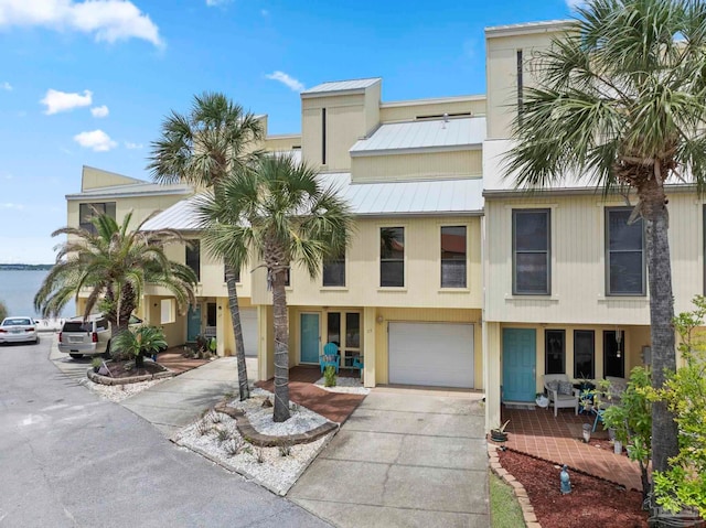 8520 Gulf Blvd Unit 23, Navarre Beach, FL 32566 - view of front facade featuring concrete driveway, a garage, a standing seam roof, and metal roof
