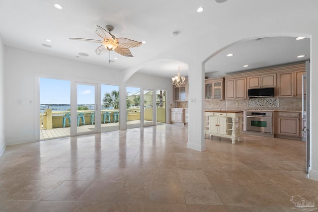 8520 Gulf Blvd Unit 23, Navarre Beach, FL 32566 - unfurnished living room featuring recessed lighting, arched walkways, a ceiling fan, a chandelier, and baseboards
