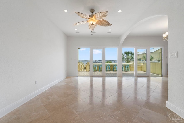 8520 Gulf Blvd Unit 23, Navarre Beach, FL 32566 - empty room featuring plenty of natural light, baseboards, arched walkways, recessed lighting, and a chandelier