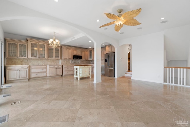 8520 Gulf Blvd Unit 23, Navarre Beach, FL 32566 - kitchen with stainless steel fridge with ice dispenser, arched walkways, a ceiling fan, open floor plan, and black microwave