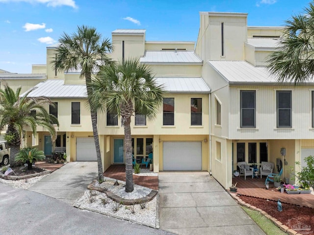 8520 Gulf Blvd Unit 23, Navarre Beach, FL 32566 - view of front facade featuring driveway, an attached garage, and metal roof