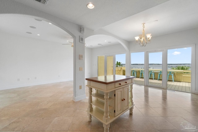8520 Gulf Blvd Unit 23, Navarre Beach, FL 32566 - kitchen featuring arched walkways, open shelves, open floor plan, cream cabinets, and recessed lighting