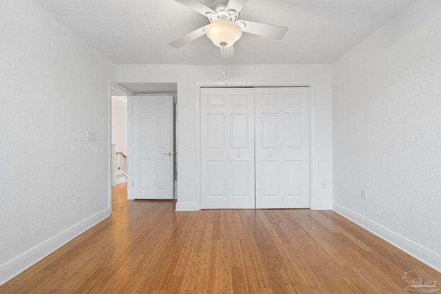 8520 Gulf Blvd Unit 23, Navarre Beach, FL 32566 - unfurnished bedroom with baseboards, light wood finished floors, a closet, and a ceiling fan