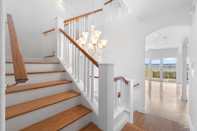8520 Gulf Blvd Unit 23, Navarre Beach, FL 32566 - stairs with arched walkways, a chandelier, wood finished floors, and recessed lighting