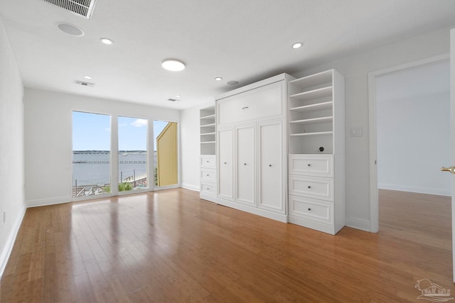 8520 Gulf Blvd Unit 23, Navarre Beach, FL 32566 - unfurnished bedroom featuring baseboards, light wood-style flooring, recessed lighting, and a water view