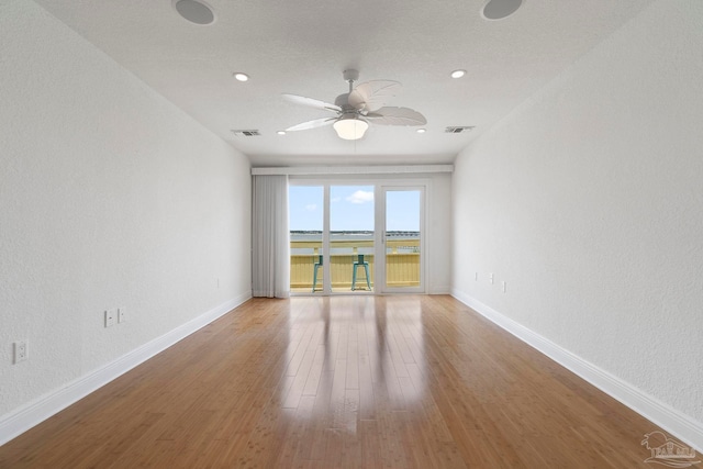 8520 Gulf Blvd Unit 23, Navarre Beach, FL 32566 - empty room featuring a ceiling fan, baseboards, wood finished floors, a textured wall, and recessed lighting
