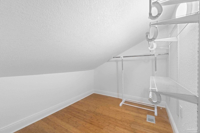 8520 Gulf Blvd Unit 23, Navarre Beach, FL 32566 - walk in closet with wood finished floors and lofted ceiling