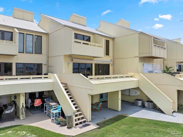 8520 Gulf Blvd Unit 23, Navarre Beach, FL 32566 - rear view of house featuring stairway, cooling unit, and a patio area