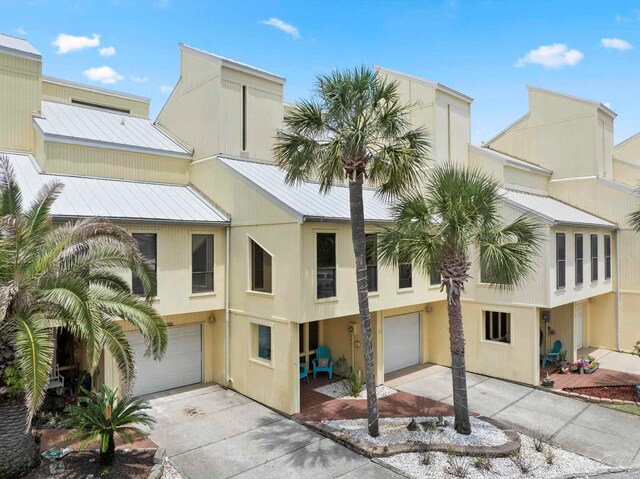 8520 Gulf Blvd Unit 23, Navarre Beach, FL 32566 - view of building exterior featuring an attached garage and concrete driveway
