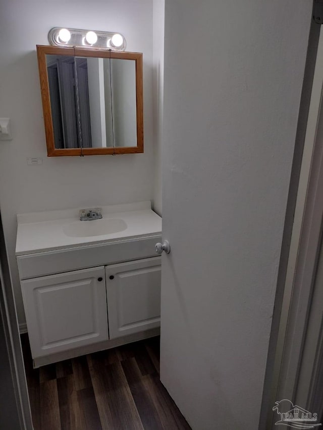 bathroom with hardwood / wood-style flooring and vanity