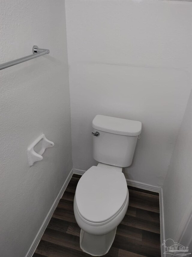 bathroom with hardwood / wood-style flooring and toilet