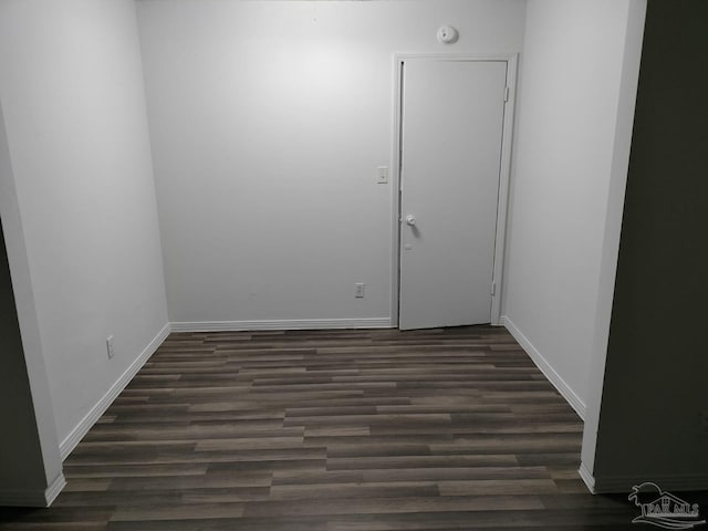 unfurnished room with dark hardwood / wood-style floors